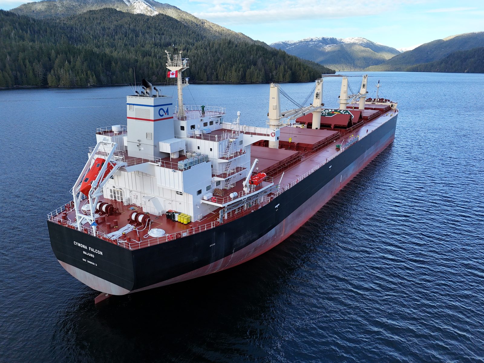 M/V Cymona Falcon, Ultramax bulk carrier, at anchor against snow-covered mountains